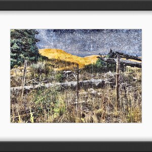 Worn Fence Under Dark Skies Light on Background Mountain image 1