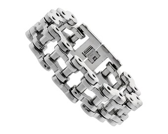 May include: A silver stainless steel chain link bracelet. The bracelet is made of multiple rows of interlocking chain links.