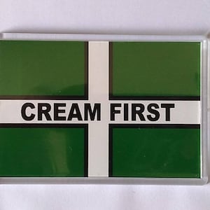 May include: A green and white flag with the words "CREAM FIRST" printed in black.