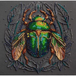 May include: A green, blue and gold beetle with wings is surrounded by a beaded floral design. The beetle is made of beads and is a close-up image.