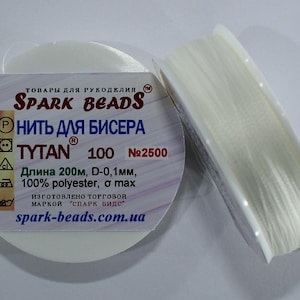 May include: A spool of white TYTAN 100 bead thread, 200m long, with a diameter of 0.1mm, made of 100% polyester. The label reads "SPARK BEADS" and "НИТЬ ДЛЯ БИСЕРА". The product is for handicrafts.