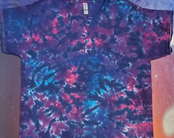 May include: A tie-dye t-shirt with a swirling pattern of blue, pink, and black.