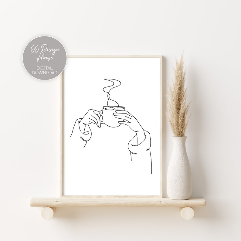 May include: Line art drawing of a hand holding a steaming cup of coffee or tea. The drawing is in black and white and is on a white background.