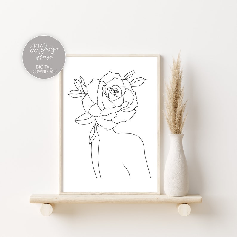 May include: A framed line art print featuring a woman's silhouette with a rose in place of a head. The artwork is in black and white, with the text "JJ Design House DIGITAL DOWNLOAD" in the upper left corner. The print is displayed on a wooden shelf.