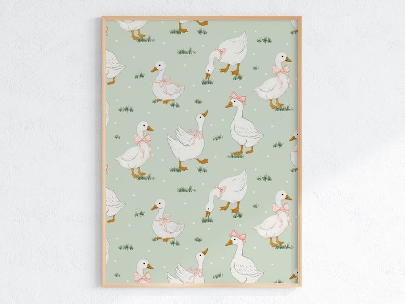 May include: A framed print featuring a repeating pattern of white geese with pink bows on a light green background. The geese are depicted in various poses, with some grazing on grass and others standing. The artwork has a whimsical, vintage aesthetic.