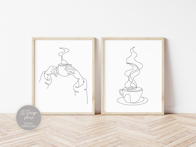 May include: Two black and white line art prints of a coffee cup with steam. One print shows a hand holding the cup, the other shows the cup on a saucer.