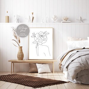 May include: A framed line art print featuring a woman's silhouette with a rose for a head. The artwork is in a minimalist style with the text "DD Design House DIGITAL DOWNLOAD". The print is displayed in a bedroom setting.