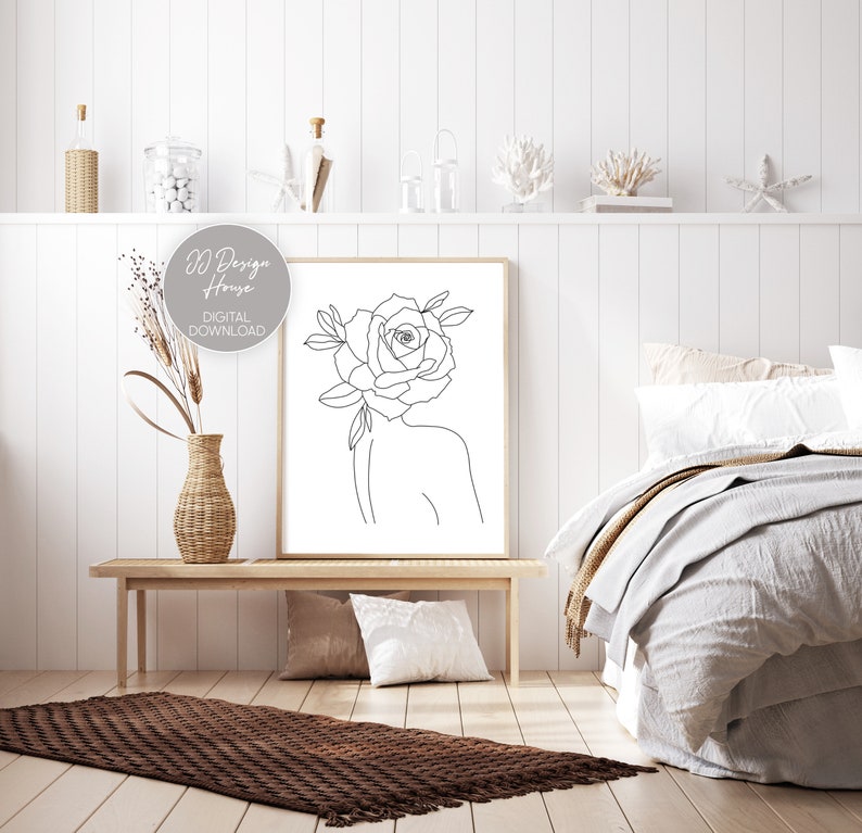 May include: A framed line art print featuring a woman's silhouette with a rose for a head. The artwork is in a minimalist style with the text "DD Design House DIGITAL DOWNLOAD". The print is displayed in a bedroom setting.