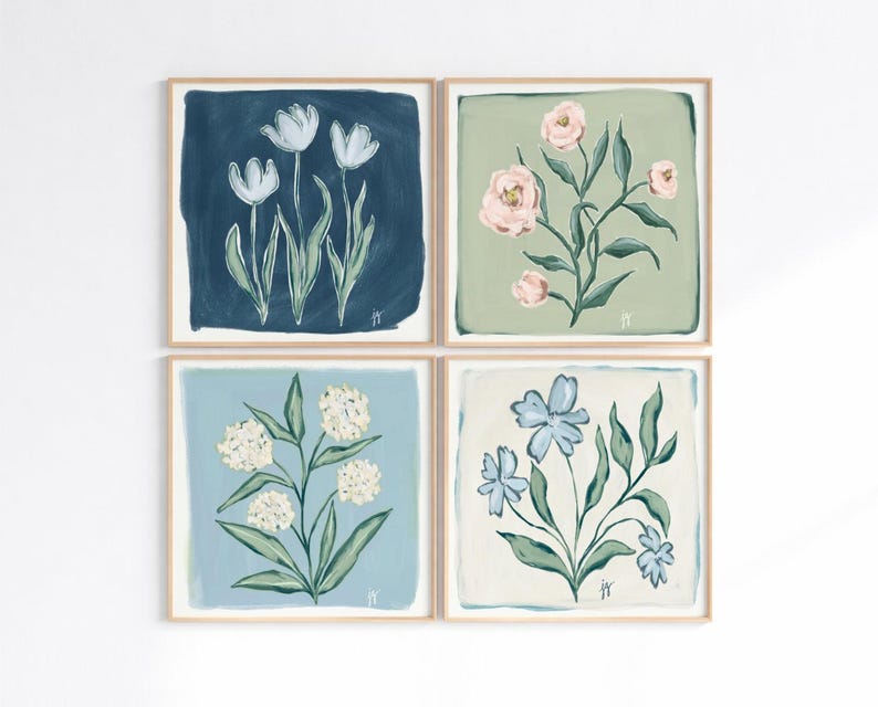 May include: Four framed floral art prints. Each square print features a different flower design: white tulips on navy, pink roses on sage green, white hydrangeas on light blue, and blue flowers on cream. The art has a painted look.