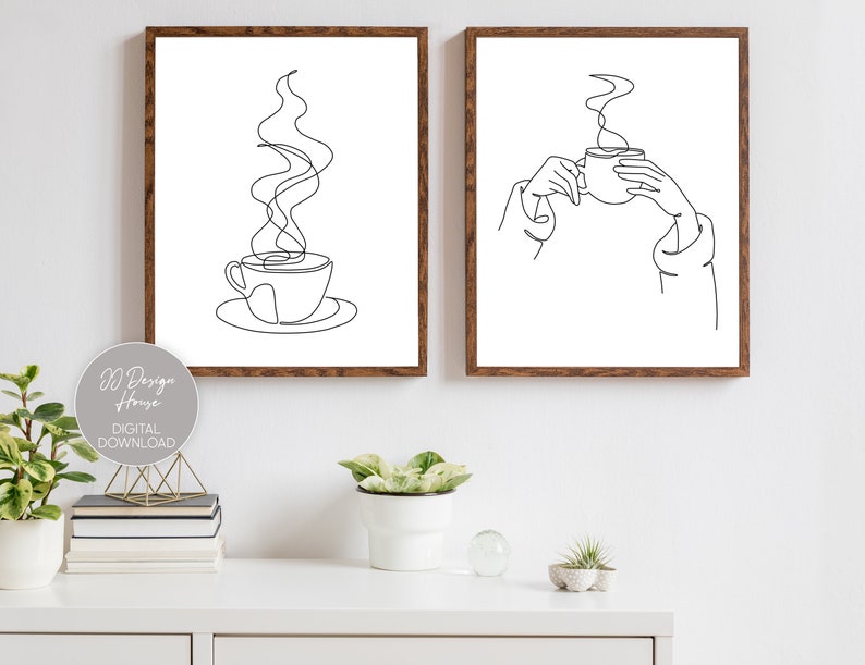 May include: Two black and white line art prints of coffee cups. The first print shows a coffee cup with steam rising from it. The second print shows a hand holding a coffee cup.