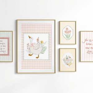 May include: A collection of framed art prints with gold frames. The prints feature illustrations of a goose with flowers, tulips, and text that reads "How wonderful life is now you're in the world" and "You'll never know dear how much I love you."