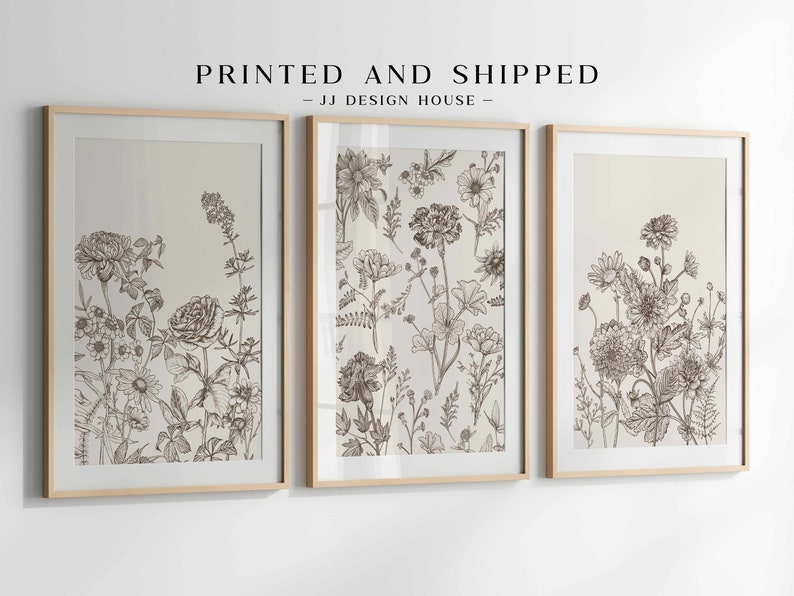 May include: Three framed botanical art prints. Each print features detailed line drawings of various flowers and foliage in shades of brown and beige. The text "PRINTED AND SHIPPED - JJ DESIGN HOUSE" is at the top.