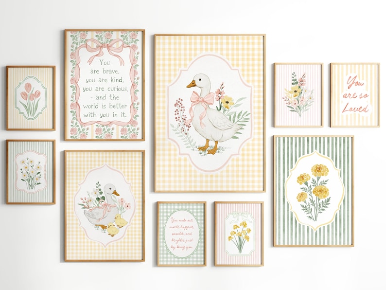 May include: A collection of framed art prints featuring watercolor illustrations of ducks, flowers, and inspirational quotes. The color palette includes soft pinks, yellows, and greens, with gingham and striped backgrounds. The prints are in wooden frames.