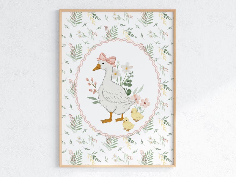 May include: A framed watercolor print featuring a white goose with a pink bow, surrounded by flowers and two yellow chicks. The artwork is set against a floral patterned background, creating a charming, pastoral scene.