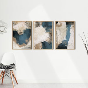 May include: Three abstract art prints with a blue, white, and brown color scheme. The prints are framed in wood and have a distressed, textured look.