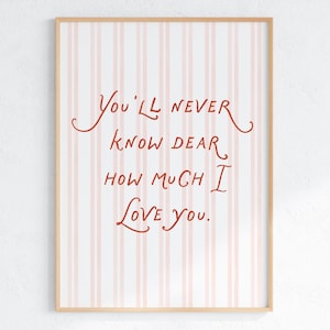 May include: A framed art print with a light wood frame. The background features vertical pink and white stripes. The text in the center reads, "You'll never know dear how much I love you," in a handwritten style, red font.
