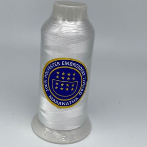 May include: White embroidery thread spool with a blue and gold label that reads "100% Polyester Embroidery Thread Maranatha".