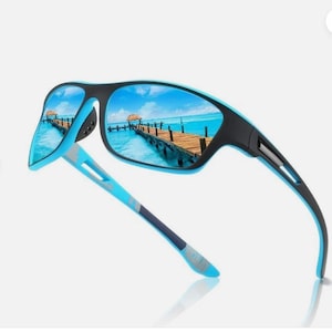 May include: Sport sunglasses with a black frame and blue accents. The lenses reflect a scenic view of a pier over turquoise water. The temples are blue and gray, offering a stylish and functional design.