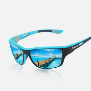 May include: Sport sunglasses with a black frame and blue accents. The lenses reflect a scenic view of a pier over turquoise water under a blue sky. The sunglasses have a sleek, modern design.