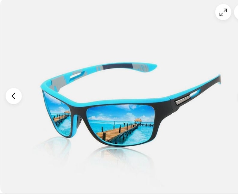 May include: Sport sunglasses with a black frame and blue accents. The lenses reflect a scenic view of a pier over turquoise water under a blue sky. The sunglasses have a sleek, modern design.