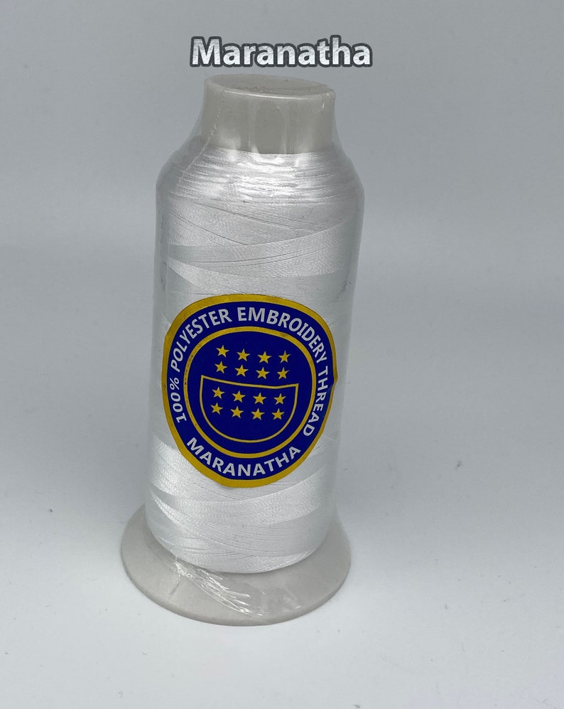 May include: White embroidery thread spool with a blue and gold label that reads "100% Polyester Embroidery Thread Maranatha".