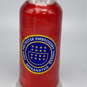 May include: A spool of red 100% polyester embroidery thread with the brand name "Maranatha" and the text "100% Polyester Embroidery Thread" on the label.
