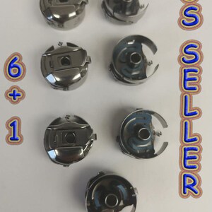 May include: Seven silver bobbins for a sewing machine. The bobbins are arranged in two rows of three and one row of one. The bobbins are all the same size and shape. The text "6 + 1 US SELLER" is visible in the image.