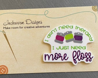 May include: White card with the text "Inchworm Designs" and "Make room for creative adventures". A white sticker with the text "I don't need therapy I just need more floss" and three spools of thread in purple, green, and purple.
