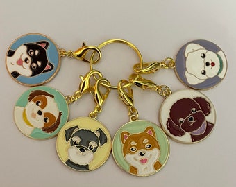 May include: A set of six gold-toned keychains with different dog breeds. Each keychain features a round enamel charm with a cartoon dog face. The dogs are a black and white Shih Tzu, a brown and white Shih Tzu, a black and white Schnauzer, a brown Shiba Inu, a white Bichon Frise, and a brown Poodle.