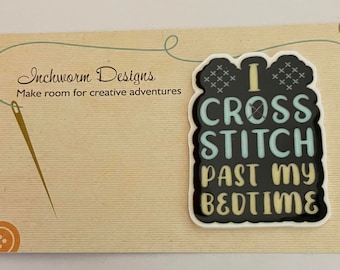 May include: A white and black cross stitch design with the text "I cross stitch past my bedtime". The design is on a white background with a black border.