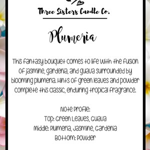 May include: A white card with black text describing a Plumeria candle from Three Sisters Candle Co. The text describes the scent as a fantasy bouquet with notes of jasmine, gardenia, guava, plumeria, green leaves, and powder.