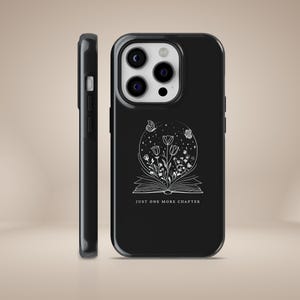 May include: Black phone case with a white design of a book with flowers and butterflies. The text "Just one more chapter" is printed below the design.