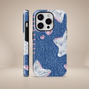 May include: A blue denim phone case with white lace accents and pink rhinestones. The case has a cutout for the camera lens.