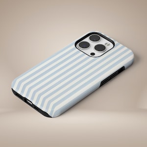 May include: A smartphone case with a light blue and white striped pattern. The case has a black border and a camera cutout. The case is designed to fit a smartphone.