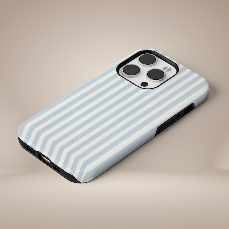 May include: A smartphone case with a light blue and white striped pattern. The case has a black border and a camera cutout. The case is designed to fit a smartphone.