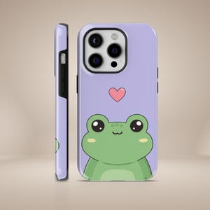 May include: A purple phone case with a cartoon frog and a pink heart. The frog is green with big eyes and a smile.