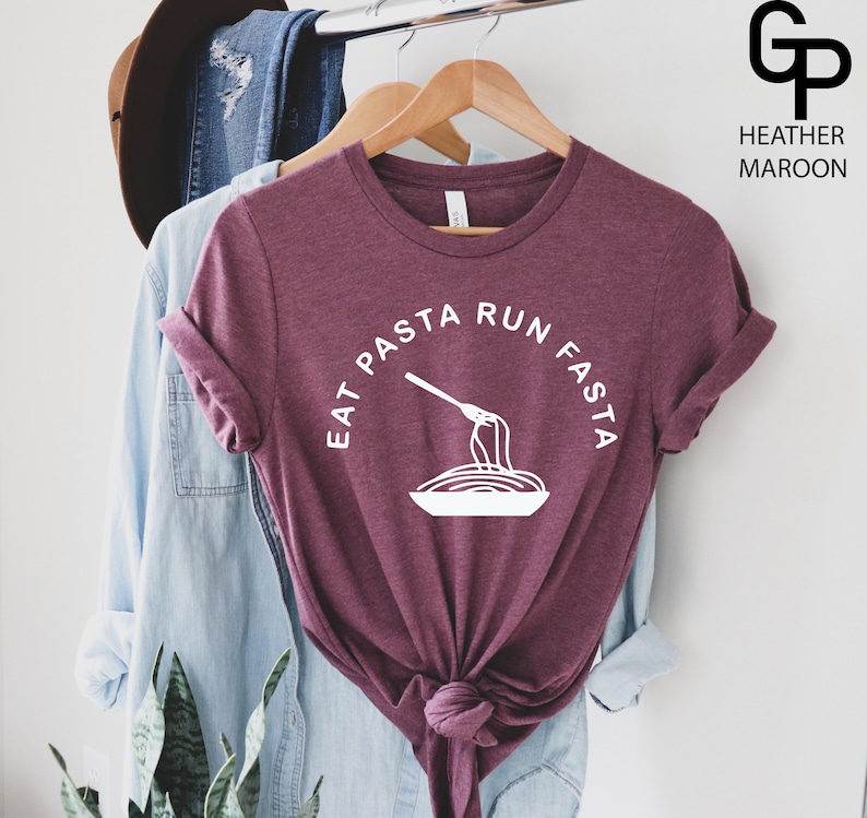 May include: A heather maroon t-shirt with a white graphic that says "Eat Pasta Run Fasta" with a fork and spaghetti illustration.