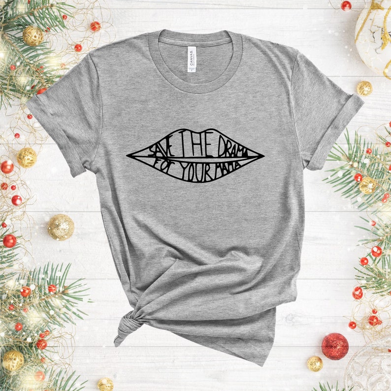 May include: Grey t-shirt with a black graphic of a mouth with the text "Save the drama for your mama" inside.