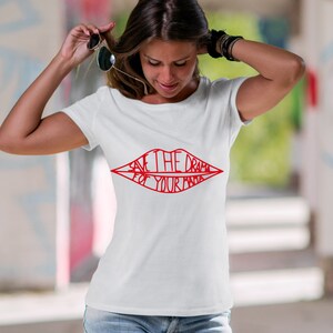 May include: White t-shirt featuring a red graphic of a pair of lips with the text "Save the drama for your mama" inside.