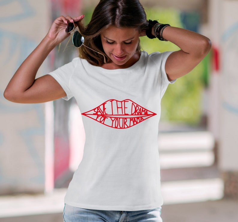 May include: White t-shirt featuring a red graphic of a pair of lips with the text "Save the drama for your mama" inside.