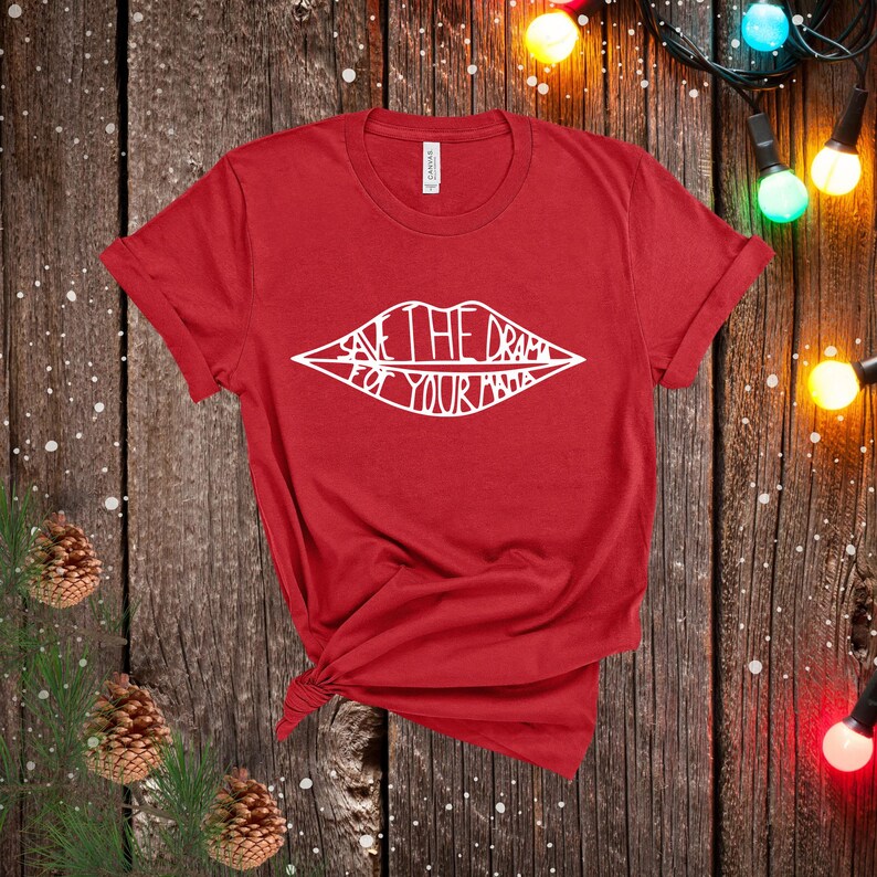 May include: Red t-shirt with a white outline of a pair of lips with the text "Save the drama for your mama" inside.