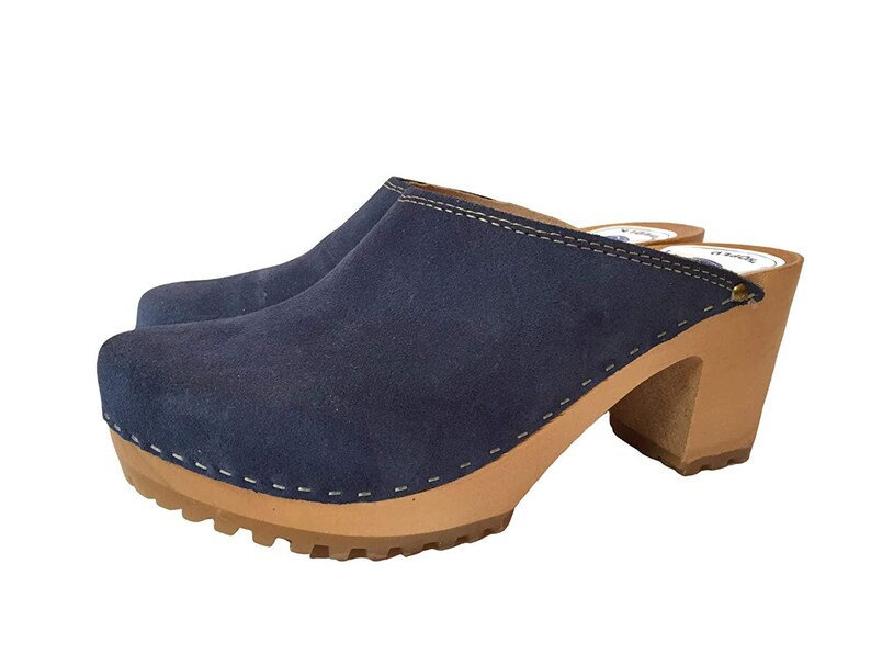May include: Blue suede clogs with a wooden heel and a stitched seam around the top edge.