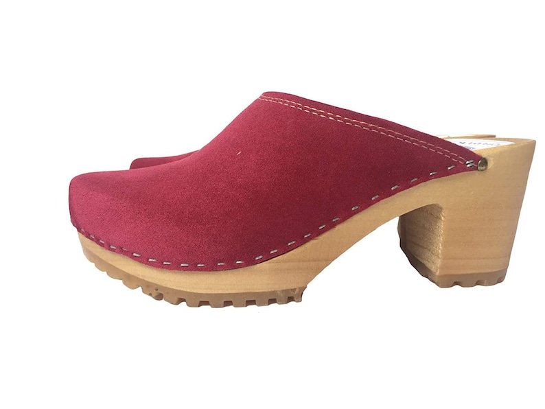 May include: Red suede clogs with a wooden heel and a thick, textured sole.