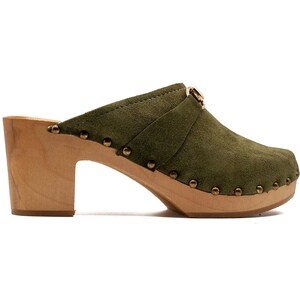 May include: Green suede clogs with a wooden heel and a gold buckle. The clogs have a studded design.
