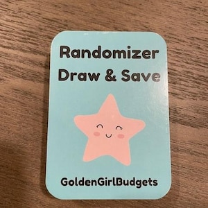 May include: A light blue card with the text "Randomizer Draw & Save" and a pink cartoon star with a smiling face. The text "GoldenGirlBudgets" is at the bottom of the card.