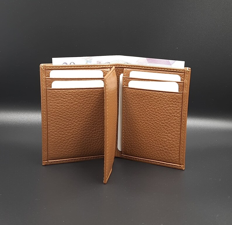 May include: A brown leather wallet with multiple card slots and a billfold. The wallet is open and empty.