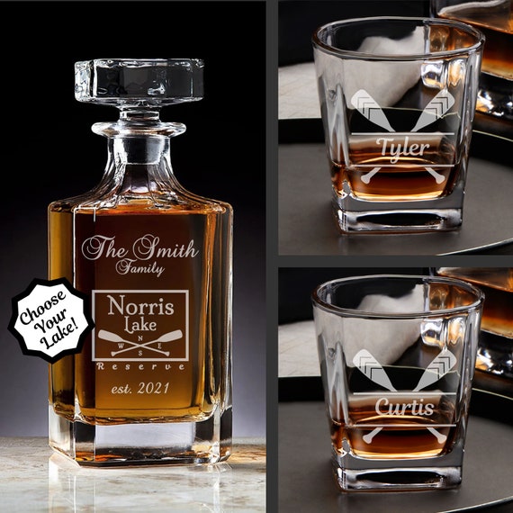 A whiskey decanter set engraved with a custom lake map — turns a specific place someone loves into a centerpiece for their home bar.