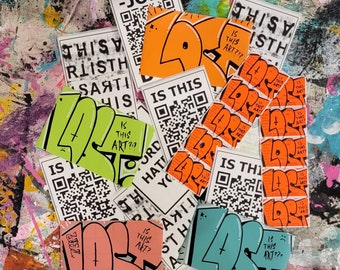 Puede incluir: Una colección de pegatinas coloridas con varios diseños y textos, incluyendo "Is This Art?" y "This Is Art". Las pegatinas están sobre un fondo texturizado.