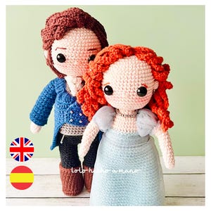 May include: A crocheted doll couple, a man in a blue jacket and black pants and a woman in a light blue dress with red hair. The dolls are standing on a wooden surface.
