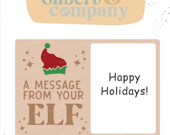 May include: A digital design file featuring the text Gilbert & Company at the top. Below, a rectangular graphic displays a red and green elf hat, the text A MESSAGE FROM YOUR ELF, and a white box containing the text Happy Holidays!